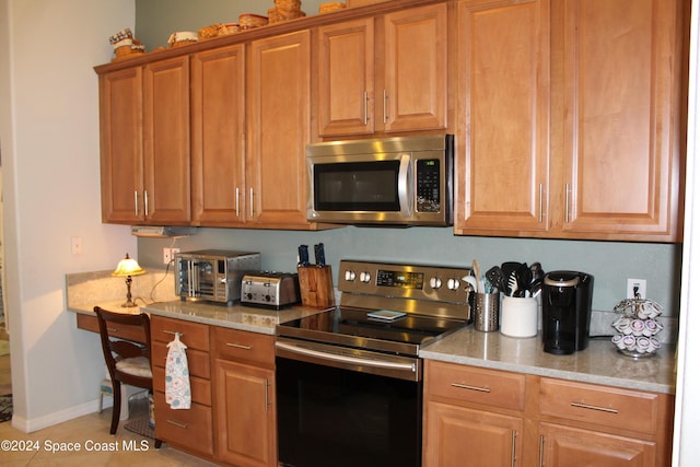 kitchen featuring light tile patterned floors and appliances with stainless steel finishes