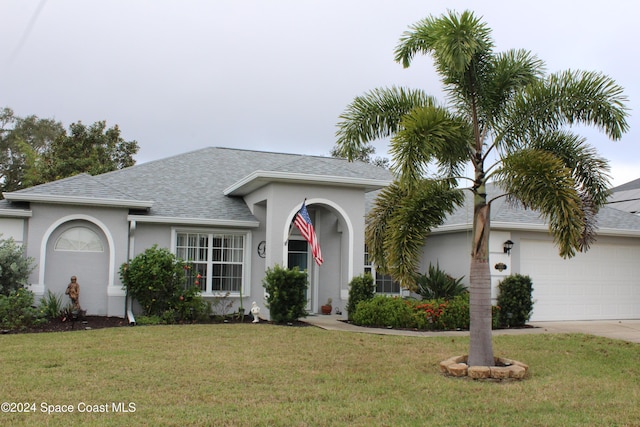 ranch-style home featuring a front lawn and a garage