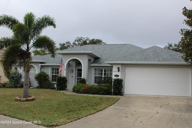 ranch-style house with a front yard and a garage