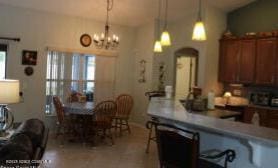 kitchen with an inviting chandelier, hanging light fixtures, and a healthy amount of sunlight