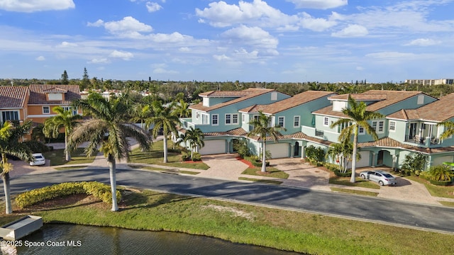 view of front facade featuring a water view and a garage