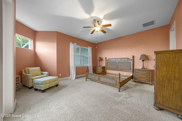 bedroom featuring a textured ceiling, carpet floors, and ceiling fan