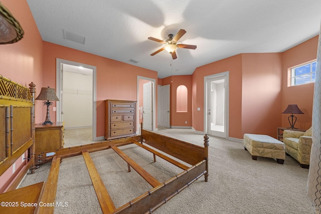 bedroom with carpet, ensuite bath, a textured ceiling, ceiling fan, and a closet