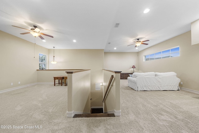 bedroom with light colored carpet and multiple windows