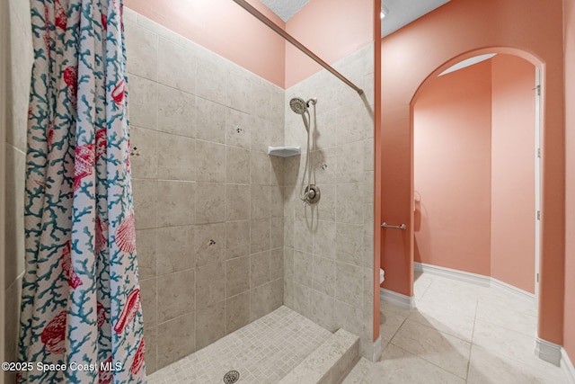 bathroom featuring curtained shower and tile patterned flooring