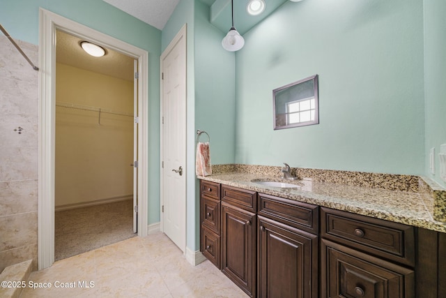 bathroom with tile patterned floors and vanity