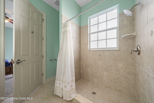 bathroom featuring a shower with curtain and ceiling fan