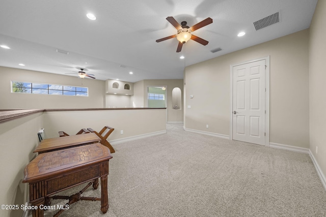 interior space with carpet floors and ceiling fan