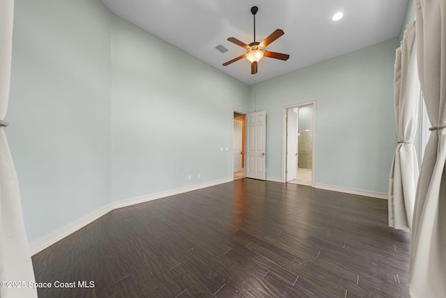 spare room with ceiling fan and dark hardwood / wood-style floors