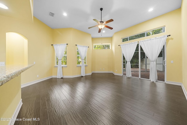 unfurnished living room featuring ceiling fan, dark hardwood / wood-style floors, and a wealth of natural light