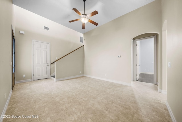 tiled spare room with ceiling fan