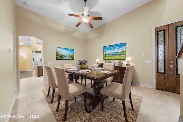 tiled dining space with ceiling fan