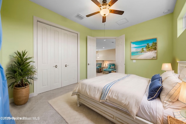 bedroom featuring ceiling fan, a closet, and light colored carpet