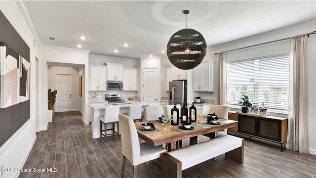 dining space featuring a textured ceiling, crown molding, and dark wood-type flooring