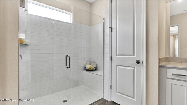 bathroom with hardwood / wood-style floors and a shower with door