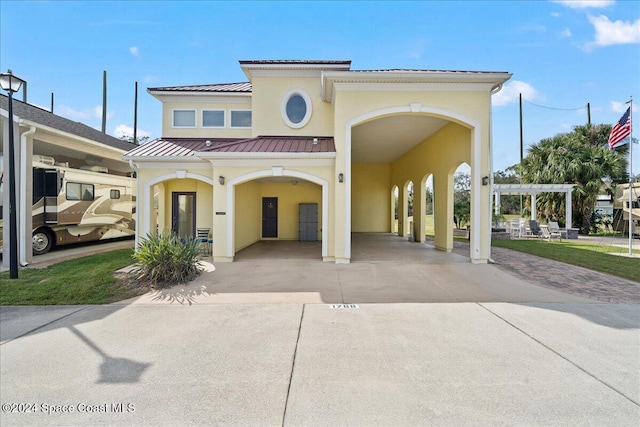 view of front of home with a carport and a pergola