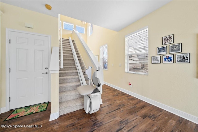 stairs featuring hardwood / wood-style floors