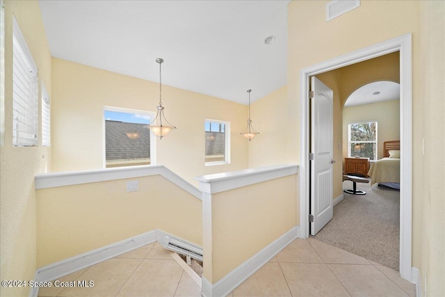 corridor featuring light colored carpet