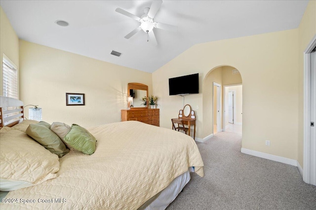 carpeted bedroom with ceiling fan and vaulted ceiling