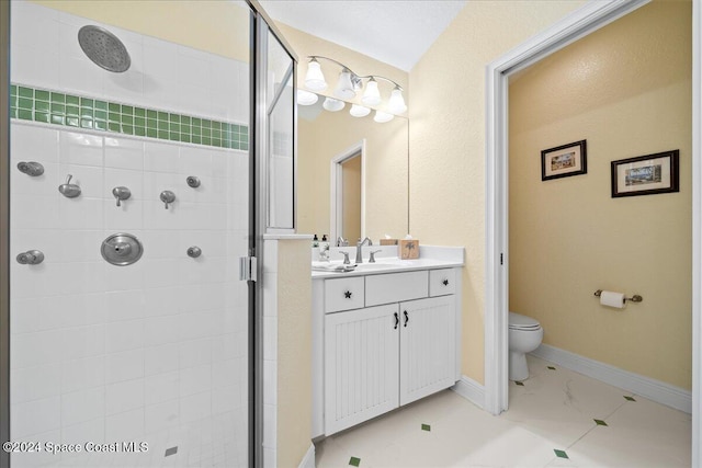 bathroom with vanity, toilet, and a shower with shower door