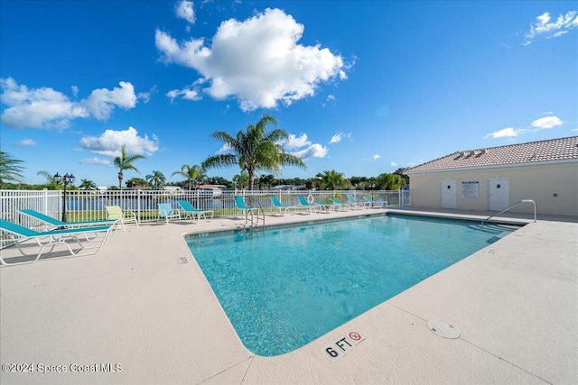 view of swimming pool with a patio area