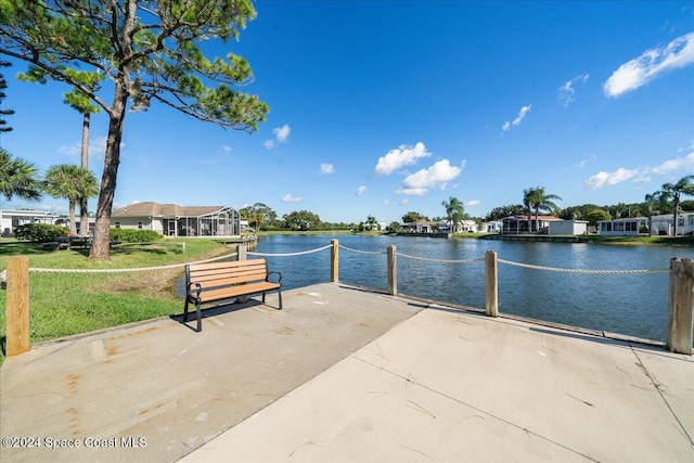 surrounding community featuring a water view and a yard