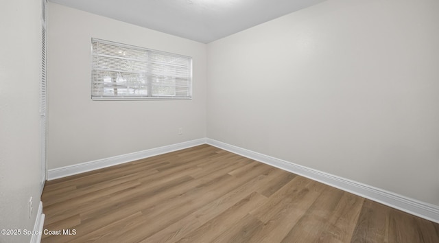 spare room featuring wood-type flooring