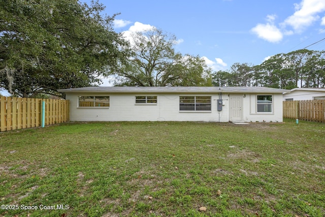 back of house featuring a yard