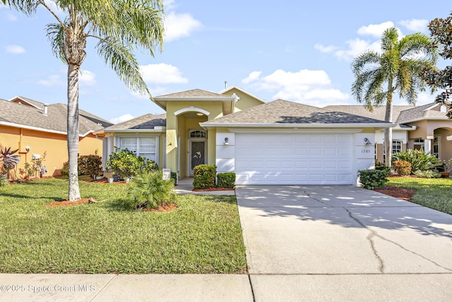 view of front of property with a garage and a front lawn