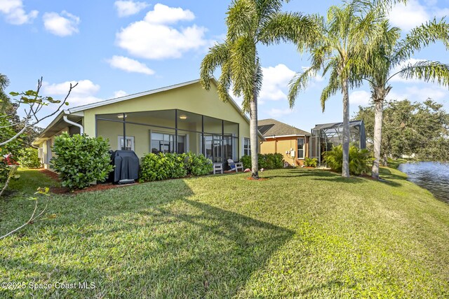 rear view of property with a yard