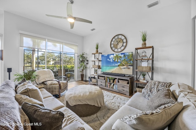 living room with hardwood / wood-style floors and ceiling fan