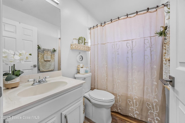 bathroom featuring a shower with shower curtain, vanity, toilet, and wood-type flooring