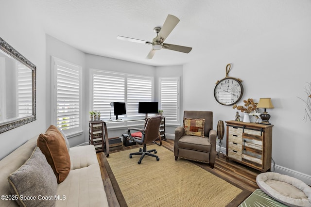 home office featuring ceiling fan and dark wood-type flooring