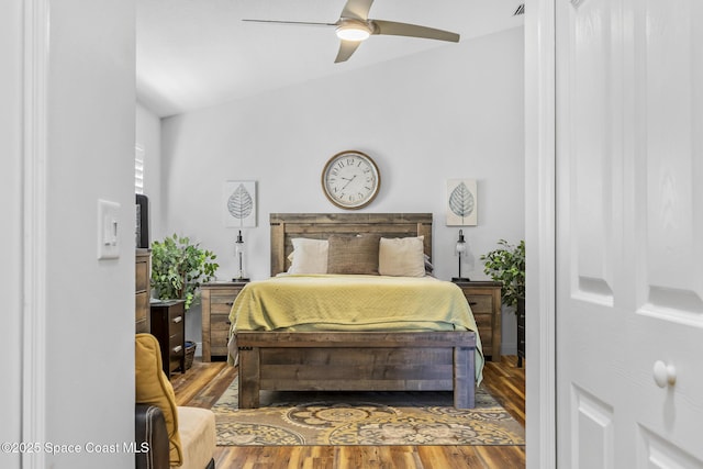 bedroom featuring hardwood / wood-style floors, ceiling fan, and lofted ceiling