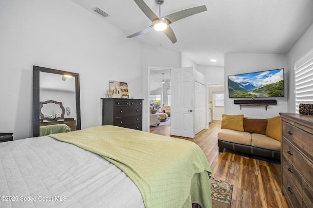 bedroom with ceiling fan, wood-type flooring, and vaulted ceiling