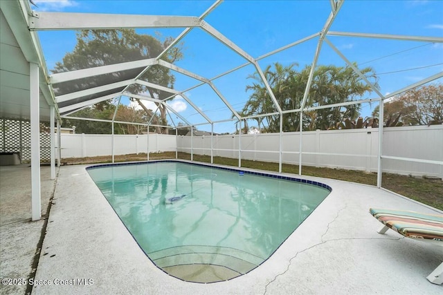 view of pool with a patio and a lanai