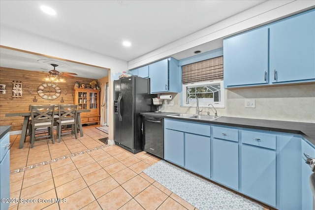 kitchen with ceiling fan, dishwasher, sink, blue cabinets, and wooden walls