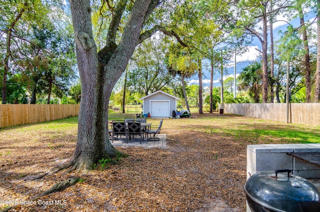 view of yard with a patio area, an outdoor structure, and fence