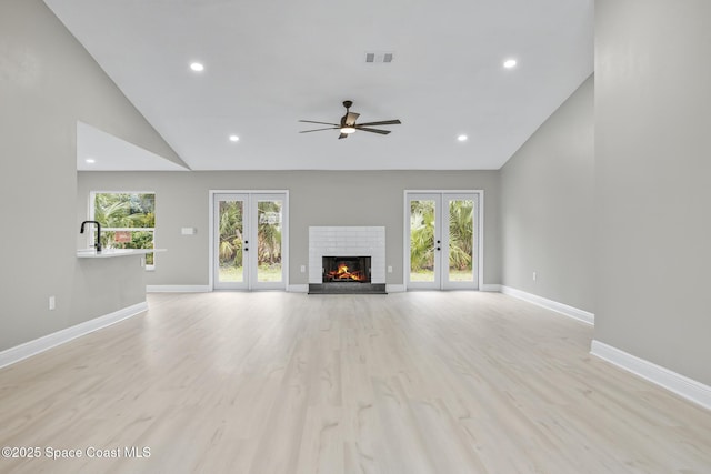 unfurnished living room with french doors, light hardwood / wood-style flooring, ceiling fan, and plenty of natural light