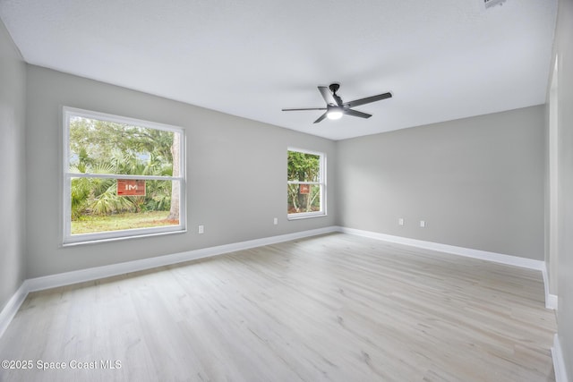 spare room featuring light wood-type flooring and ceiling fan