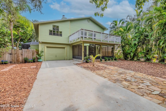 view of front of house featuring a garage and a sunroom