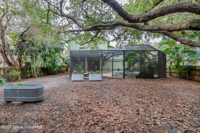 view of yard with glass enclosure