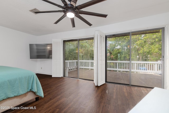 bedroom with access to exterior, dark hardwood / wood-style floors, and ceiling fan