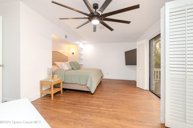 bedroom featuring ceiling fan, access to exterior, and light hardwood / wood-style flooring