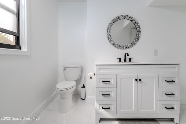 bathroom with toilet and vanity