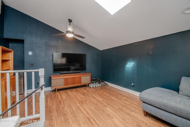 living room with ceiling fan, wood-type flooring, and vaulted ceiling