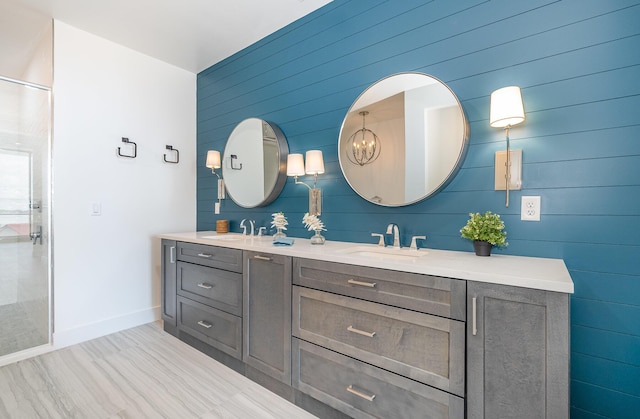 bathroom with vanity and wooden walls