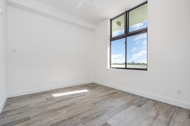 spare room featuring ceiling fan and light hardwood / wood-style flooring