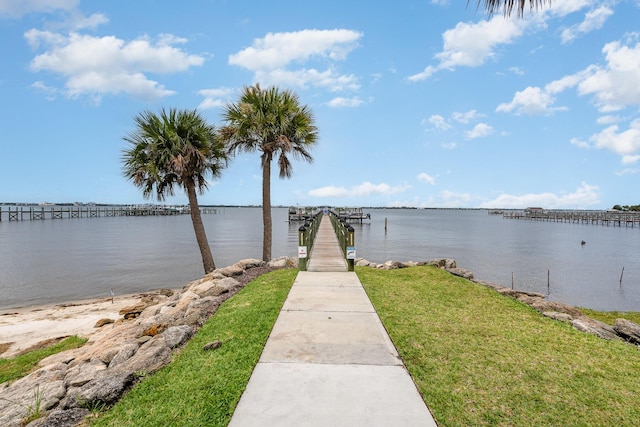 view of dock featuring a yard and a water view