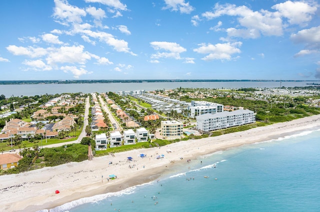 drone / aerial view featuring a water view and a beach view